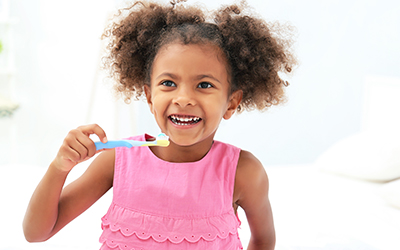 A young girl brushing her teeth