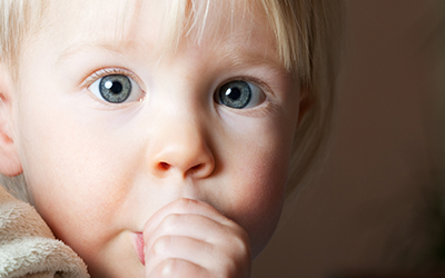 A young child sucking his thumb