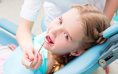 A young girl visiting the dentist
