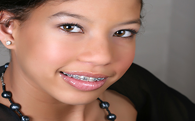 A young girl smiling with braces on