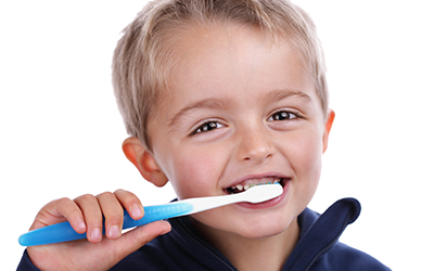 A young boy brushing his teeth