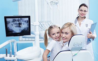 A mother and daughter looking at a dental x-ray