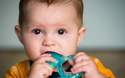 Baby chewing on teething ring