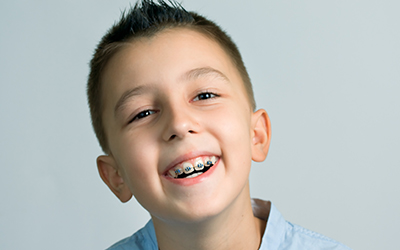 A young boy smiling with braces