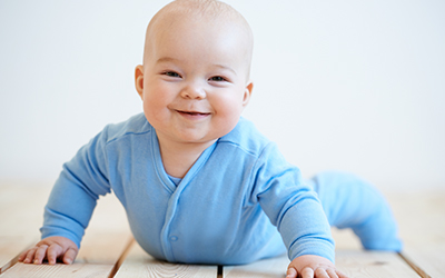 Baby smiling while crawling