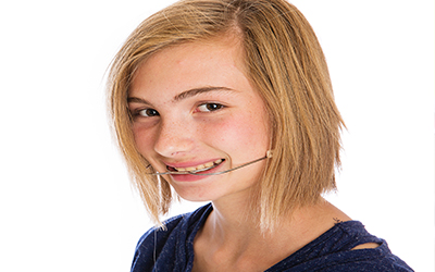 girl with orthodontic headgear