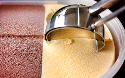 Scooping ice cream out of a tub