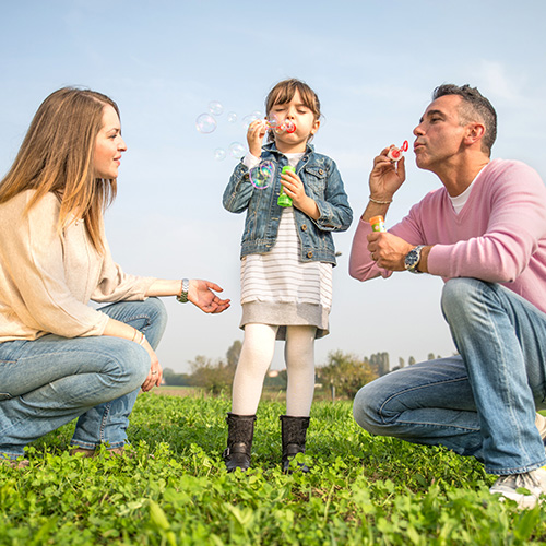 Family blowing bubbles